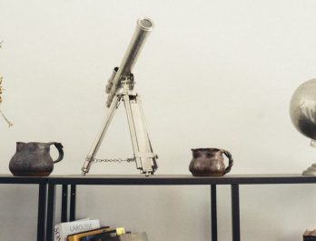 telescope, globe and vases on an end table