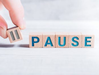 wooden cubes spelling out "pause"