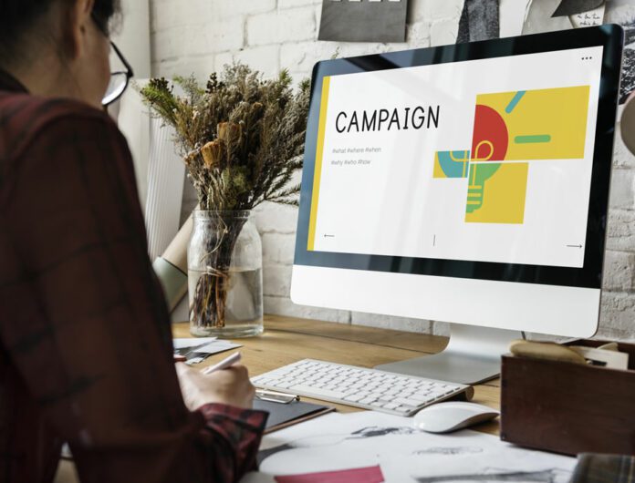 person creating a campaign proposal on their desktop